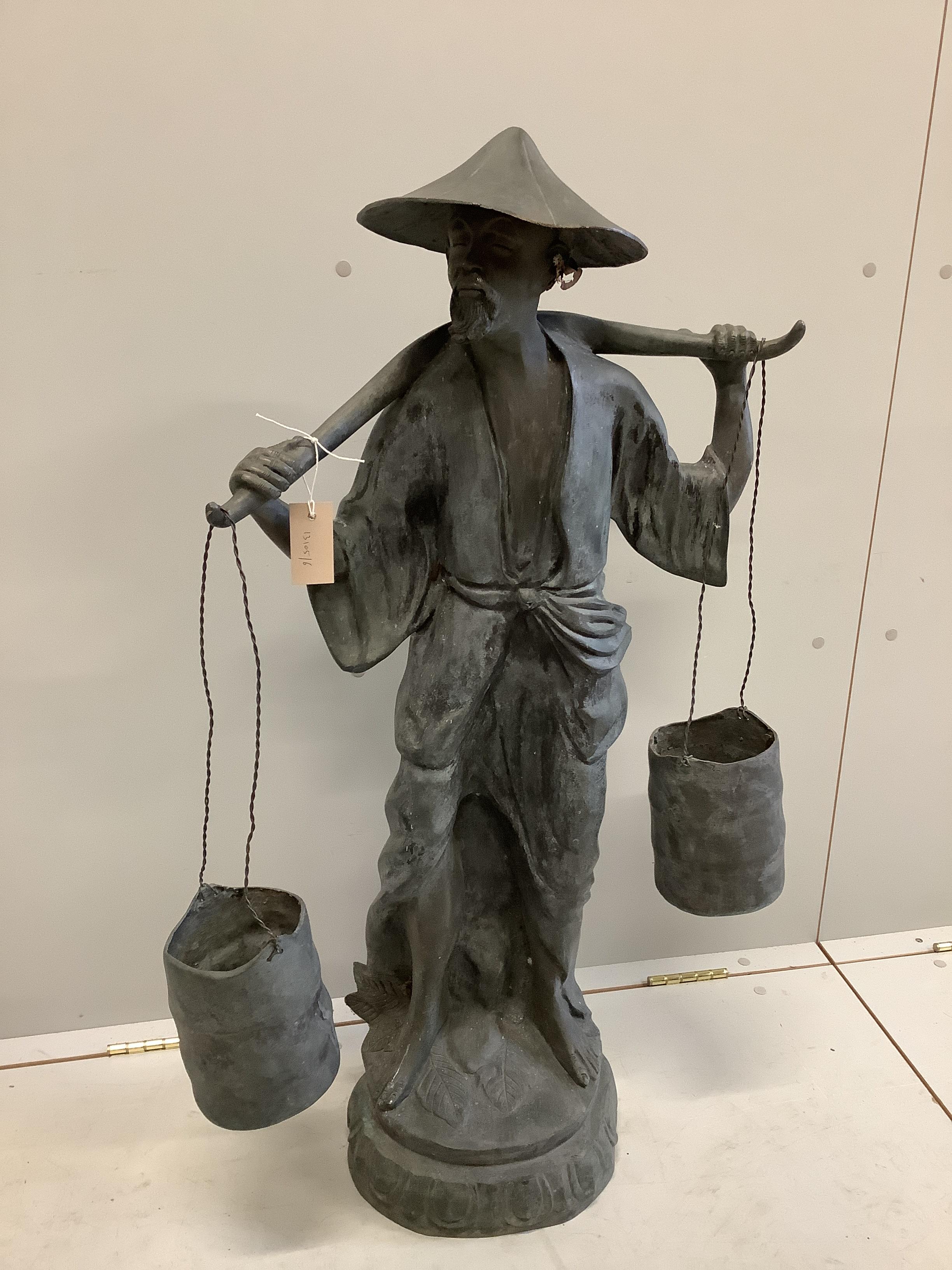 A Chinese style bronze garden ornament modelled as a water carrier, height 102cm